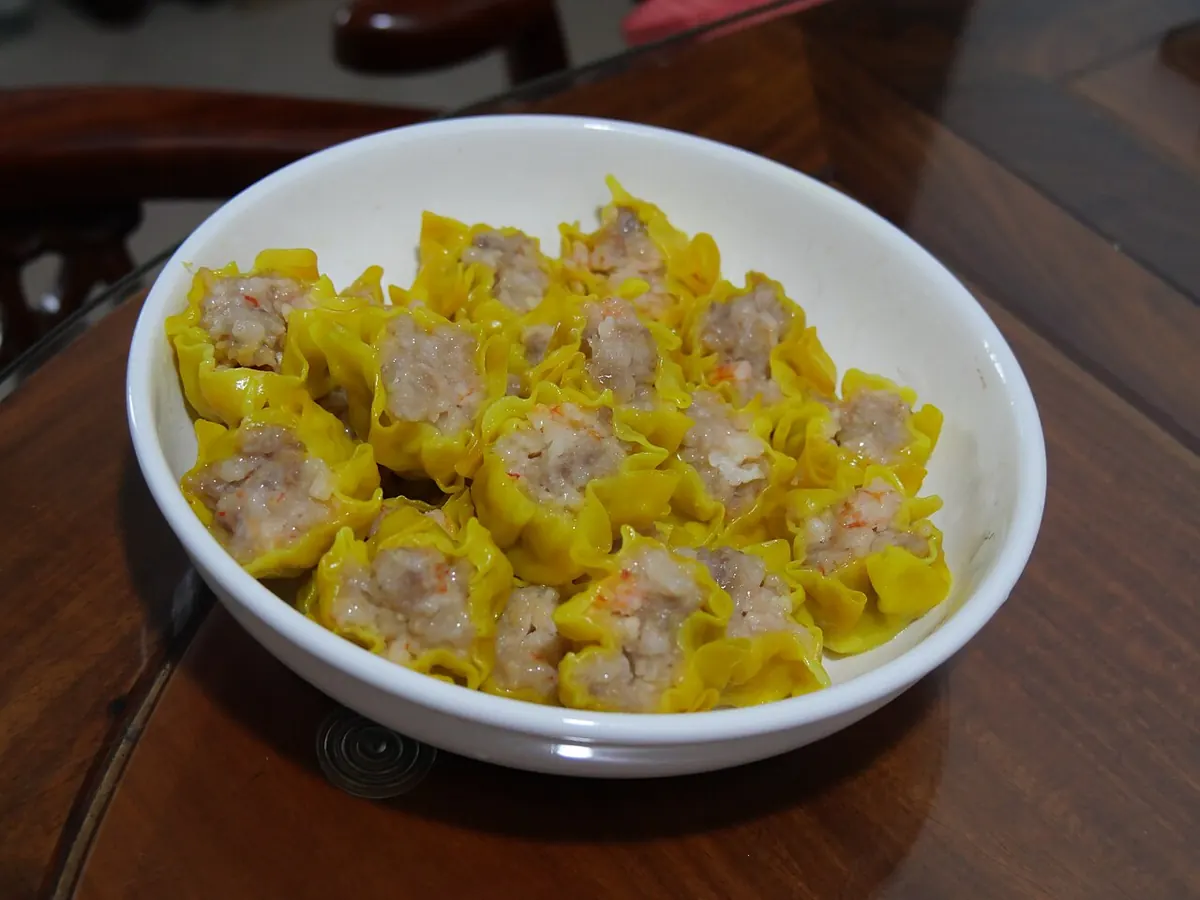 Plate of steamed Cebu siomai with chili garlic oil and calamansi at a street stall in Tisa
